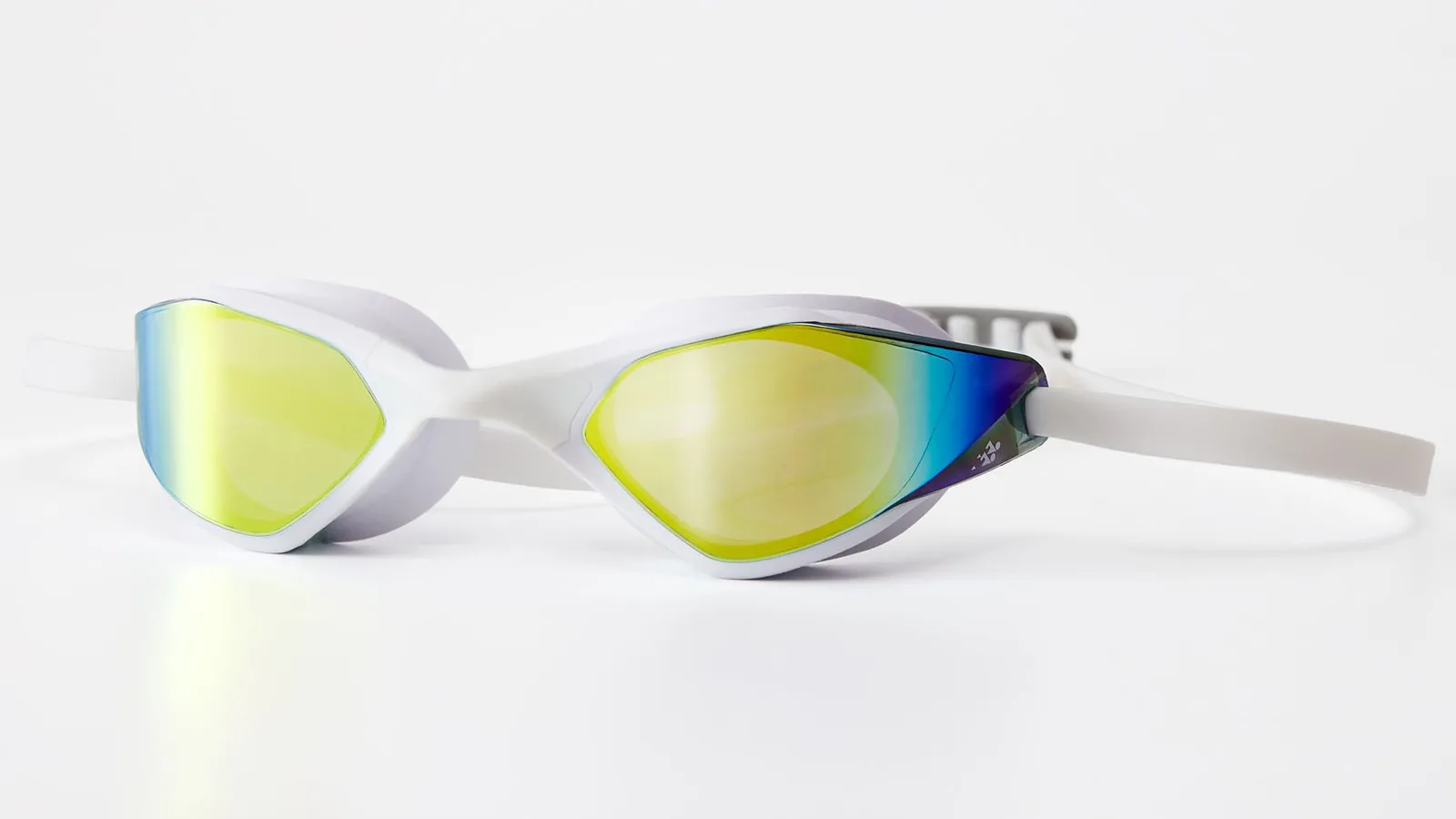The Eyeline Slash racing swim goggle in white with a gold mirror lens — a finished product from a fully audited swim goggle factory in Suzhou